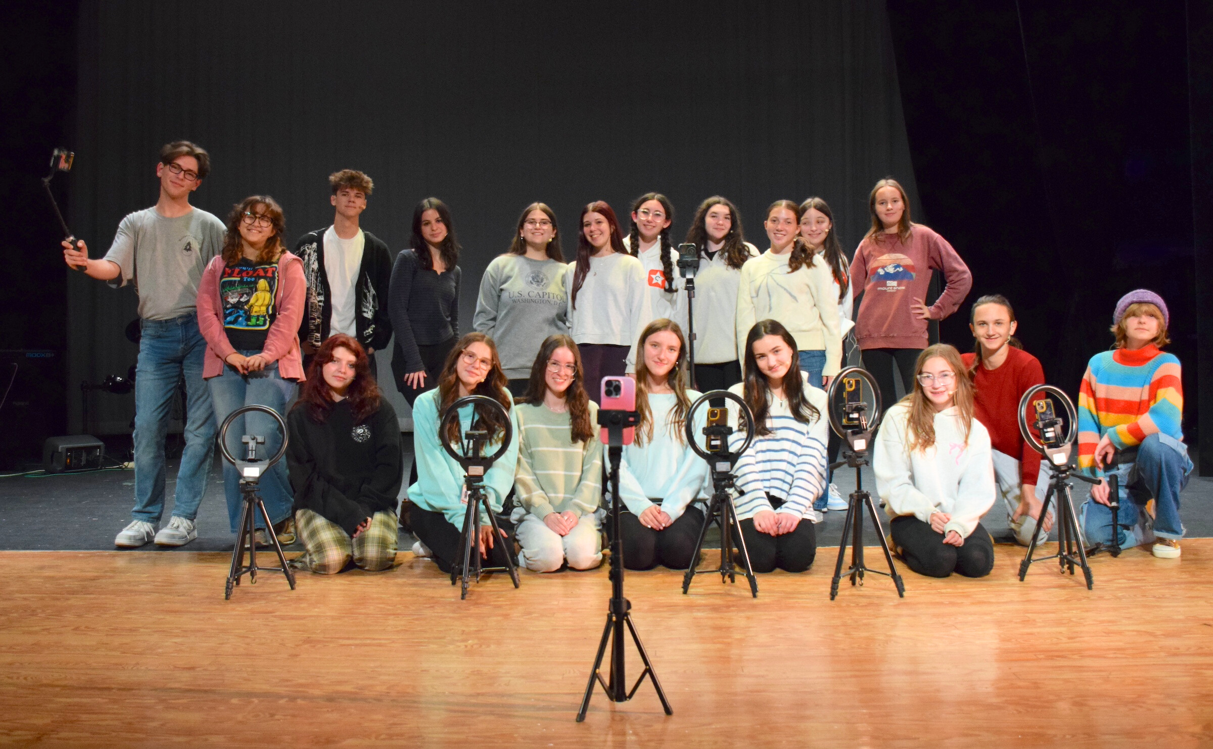 group of teen on stage with cameras